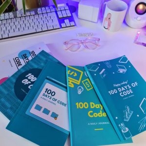 All 5 100 Days of Code Journal Covers laying on a desk
