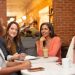 Four women speaking around a table